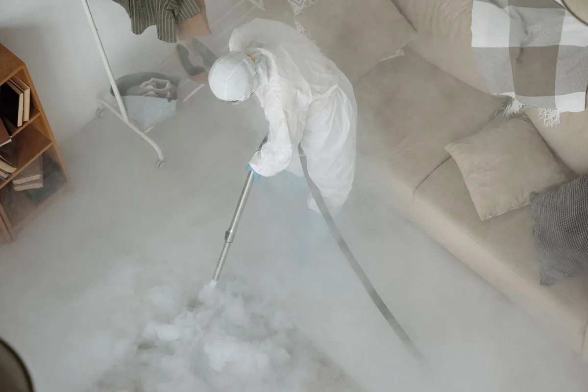 Biohazard cleanup technician in protective equipment, Ralls, TX